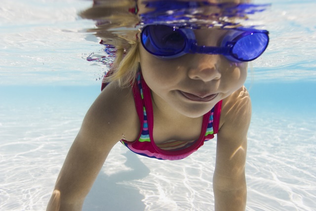 Image of a toddler swimming.